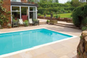 Sandstone Paving around swimming pool. Red Cheshire sandstone walling and steps. Malpas, Cheshire